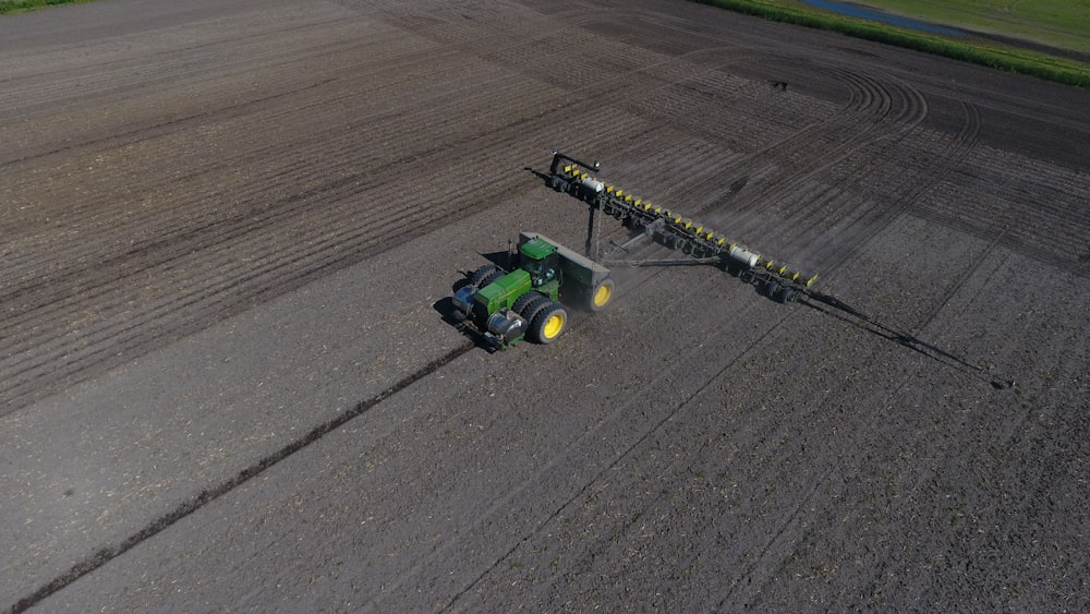 green and black tractor on gray asphalt road during daytime