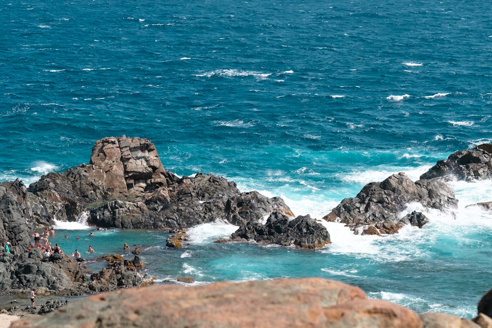 brown rock formation on sea during daytime