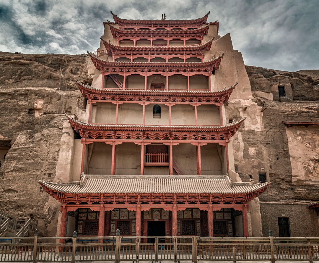 white and red concrete building under cloudy sky during daytime