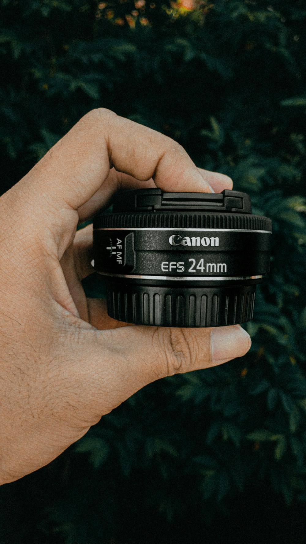 person holding black nikon camera lens