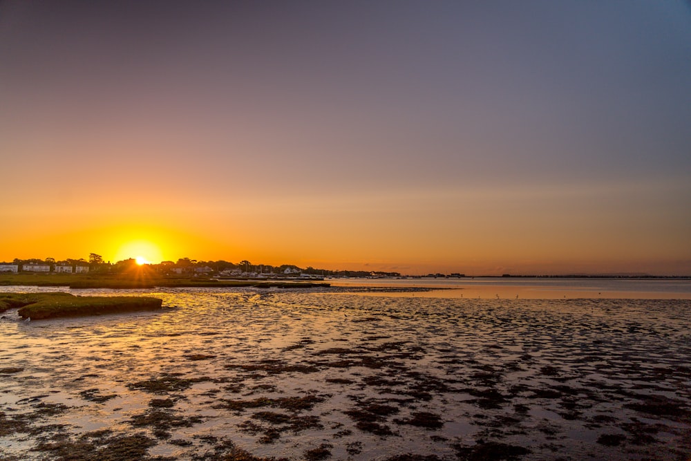 body of water during sunset