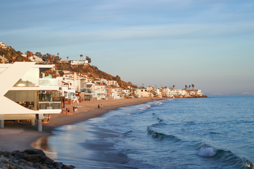 white and brown concrete buildings beside sea during daytime