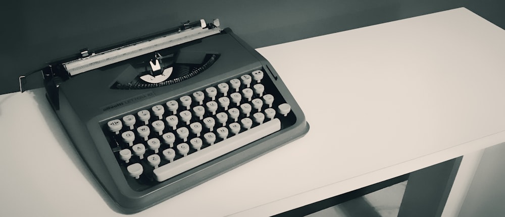 black and white typewriter on white table