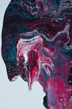 Vibrant pink and blue abstract shapes swirling on a black canvas, symbolizing creativity and freedom.