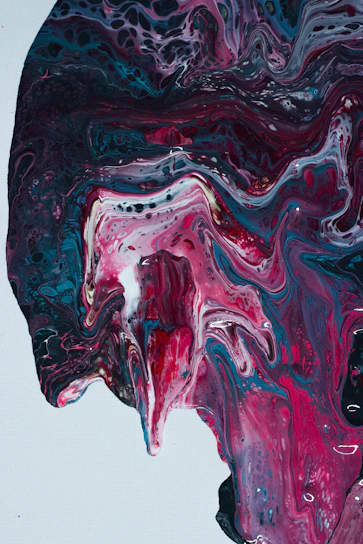 A vibrant painting featuring swirling magenta and blue hues with delicate feminine shapes.