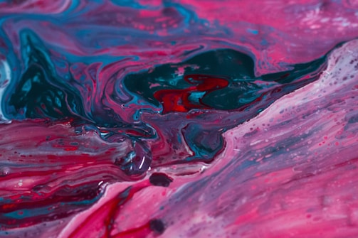 Colorful abstract fluid acrylic painting on canvas with bright blues and pinks.