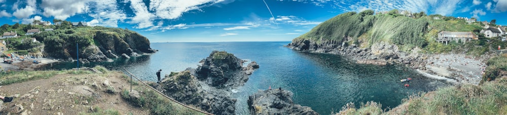 green and brown rock formation on blue sea under blue sky during daytime