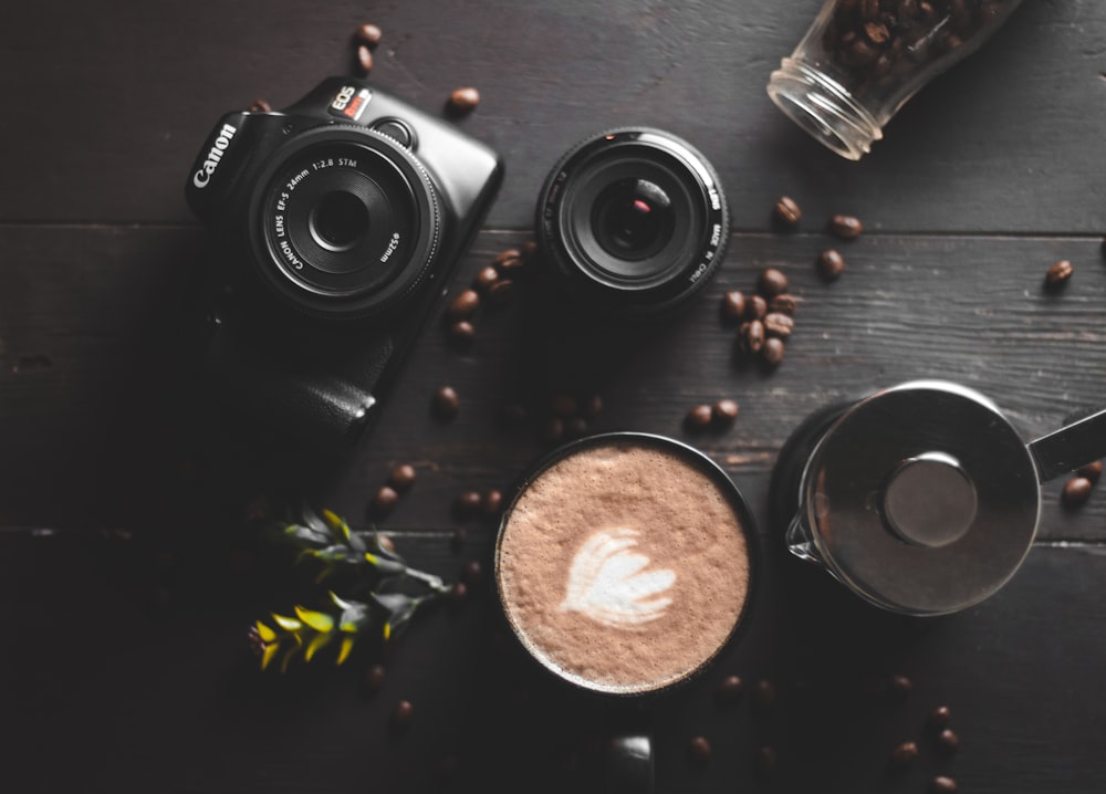 black nikon dslr camera beside brown round round ornament