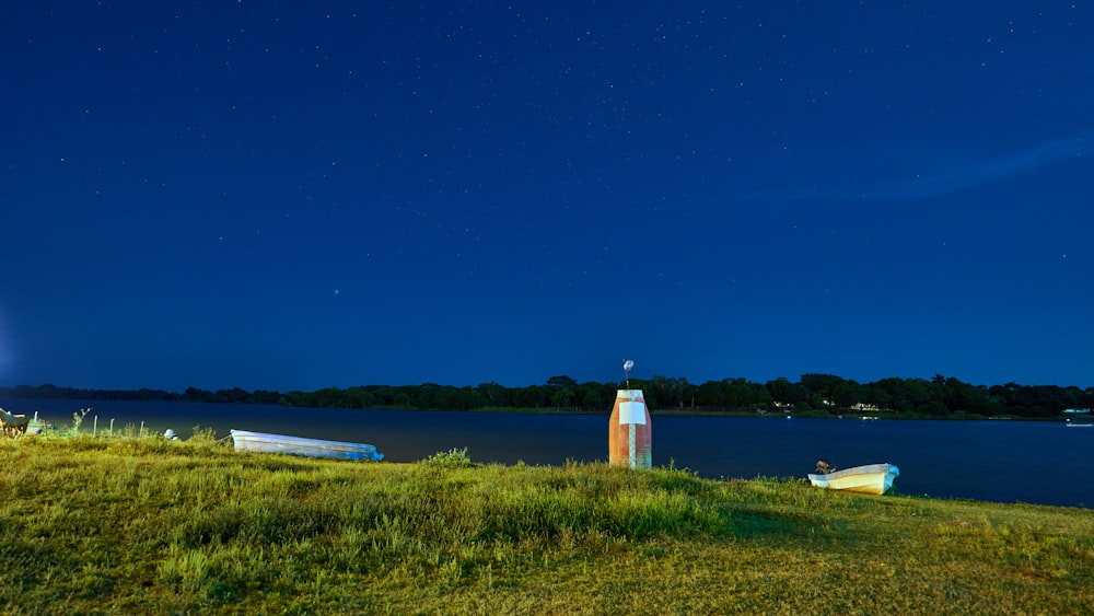 white lighthouse near body of water during daytime