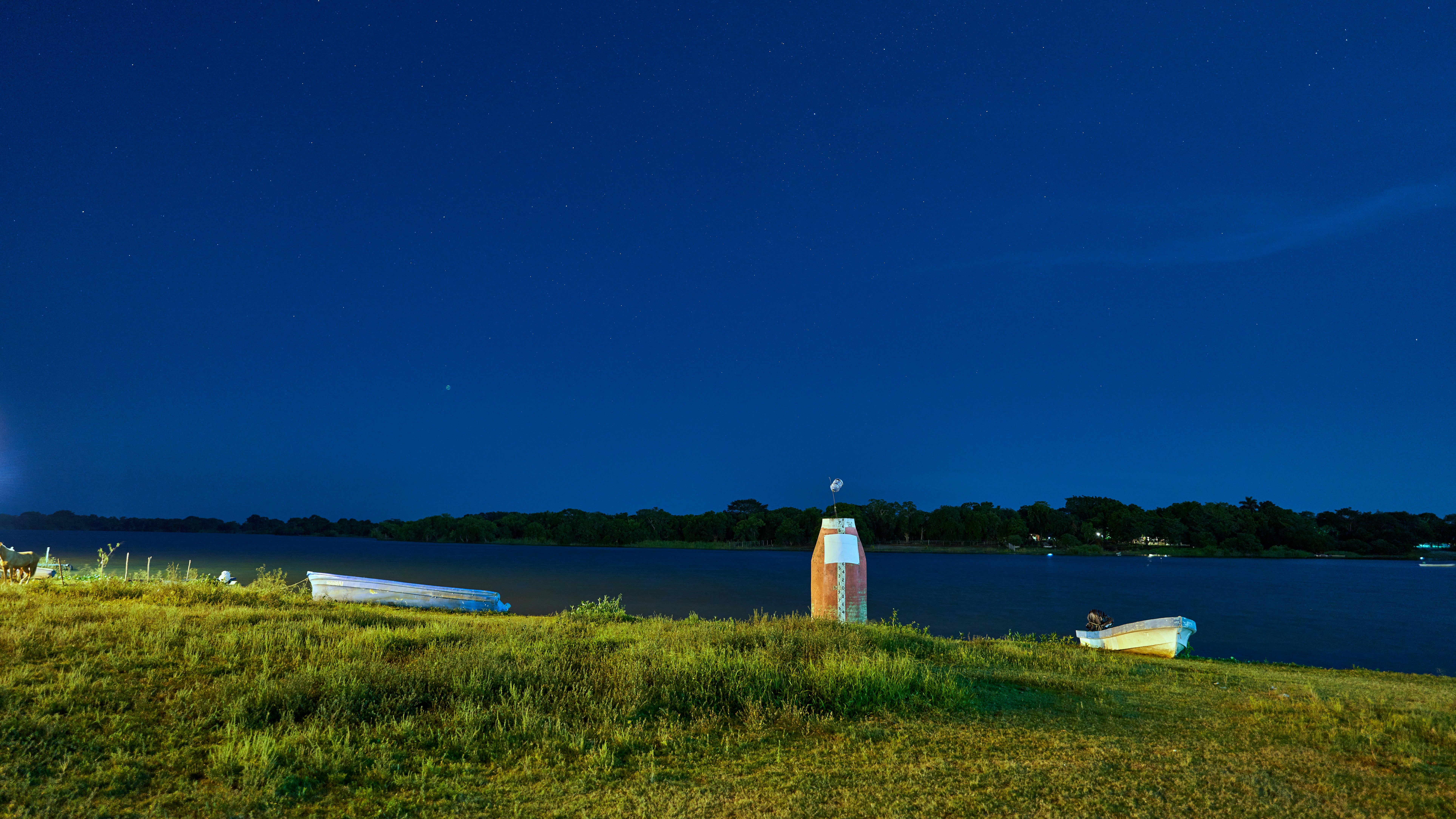 white lighthouse near body of water during daytime