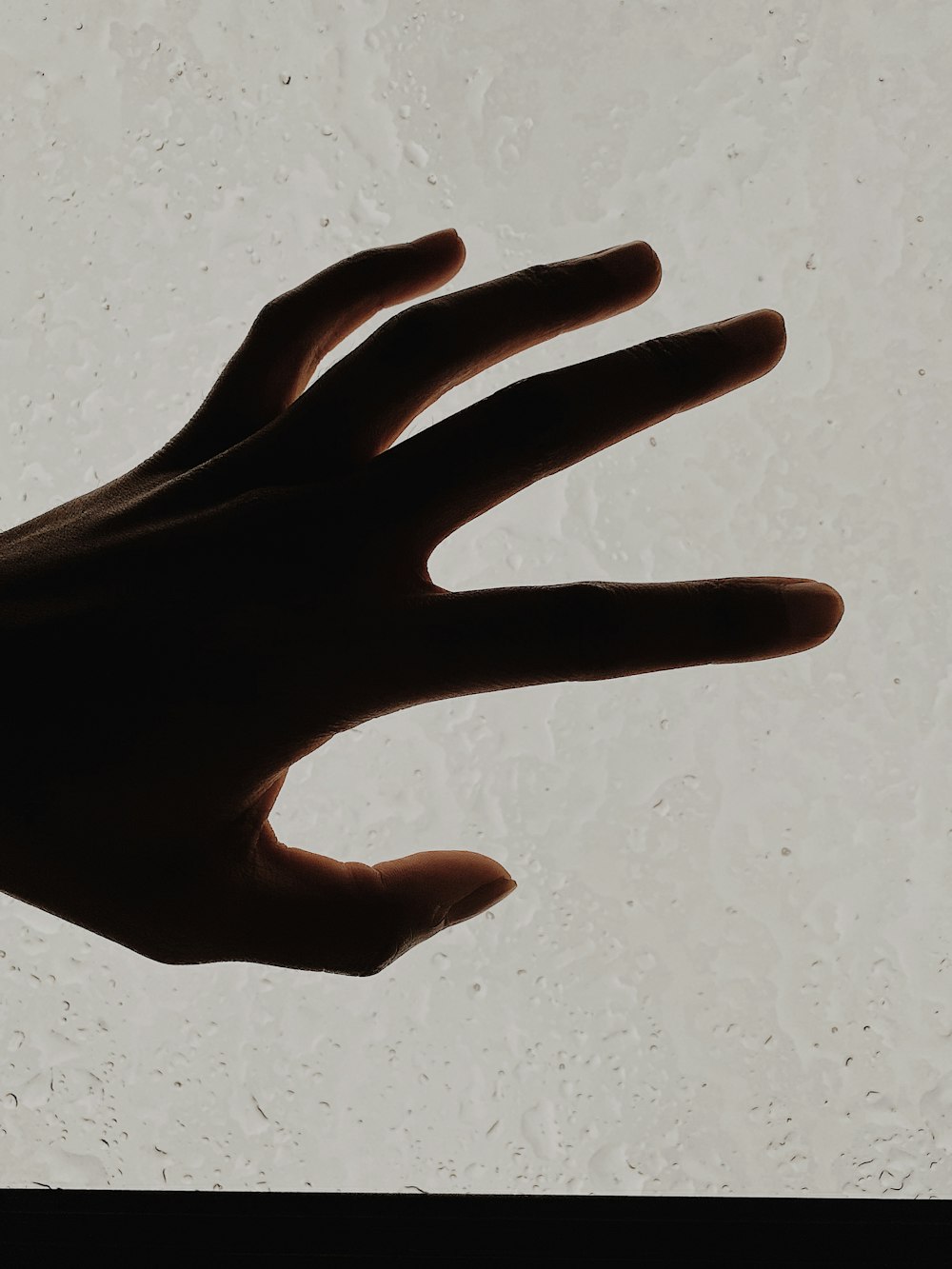 persons hand on white surface