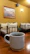 A cozy scene with a custom printed mug filled with coffee on a wooden table.