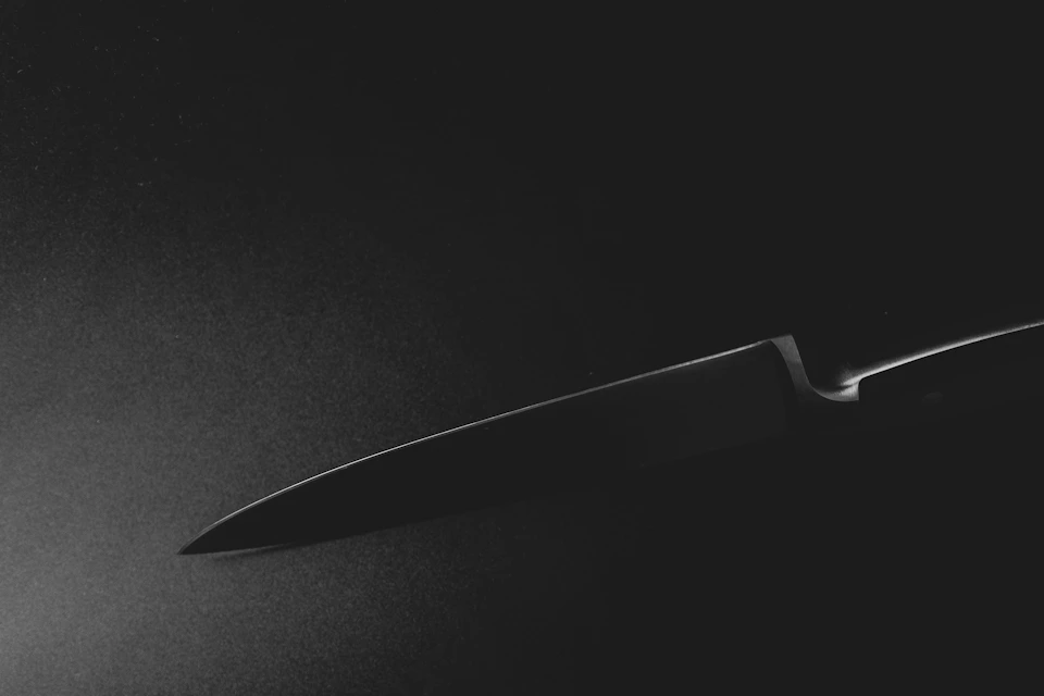 Stock photo: stainless steel knife on dark surface (placeholder for The Hoofy)