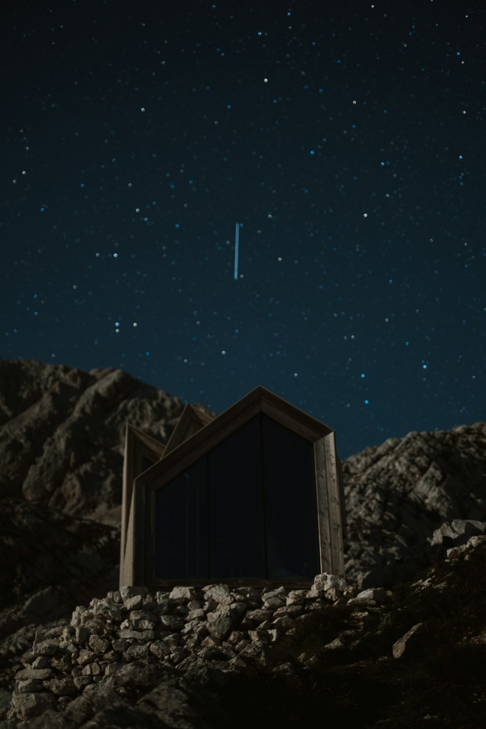 brown wooden house on snow covered ground during night time