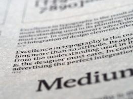 Close-up of refined typography on textured paper with taupe accents, conveying premium quality.