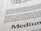 Close-up view of printed text on a textured paper surface. The focus is on the sentence 'Excellence in typography is the result of nothing more than an attitude.' The typeface and layout suggest a refined attention to typographic detail.
