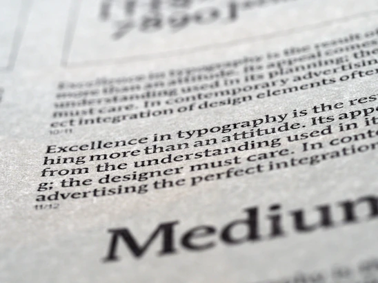 A softly lit workspace with elegant typography on a warm neutral background, highlighting the words 'Integrity & Excellence'.