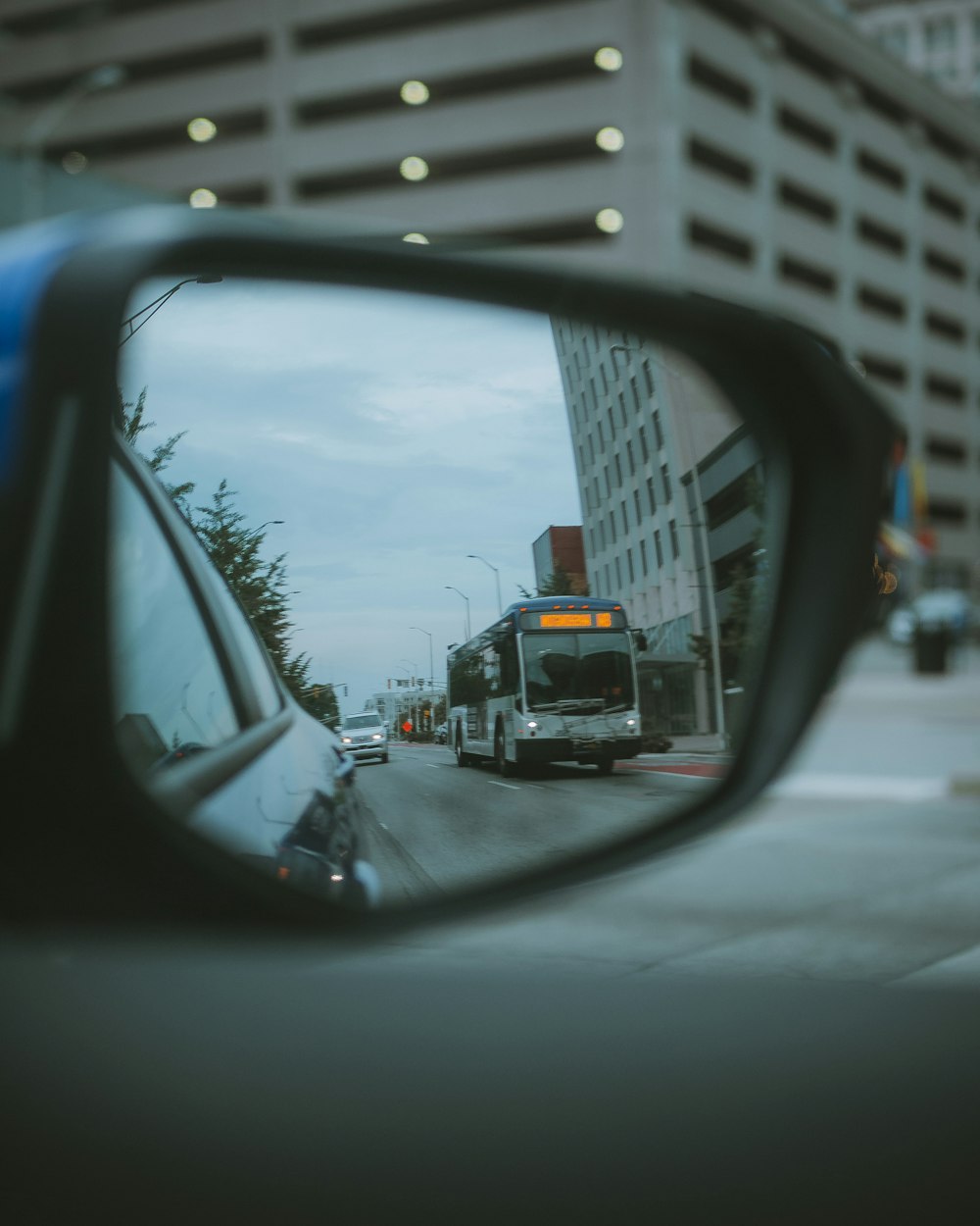 black car side mirror with water droplets