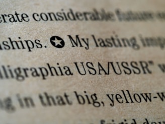 Close-up of printed text on a textured brown paper, with words like 'USA/USSR' and a star symbol preceding the text.