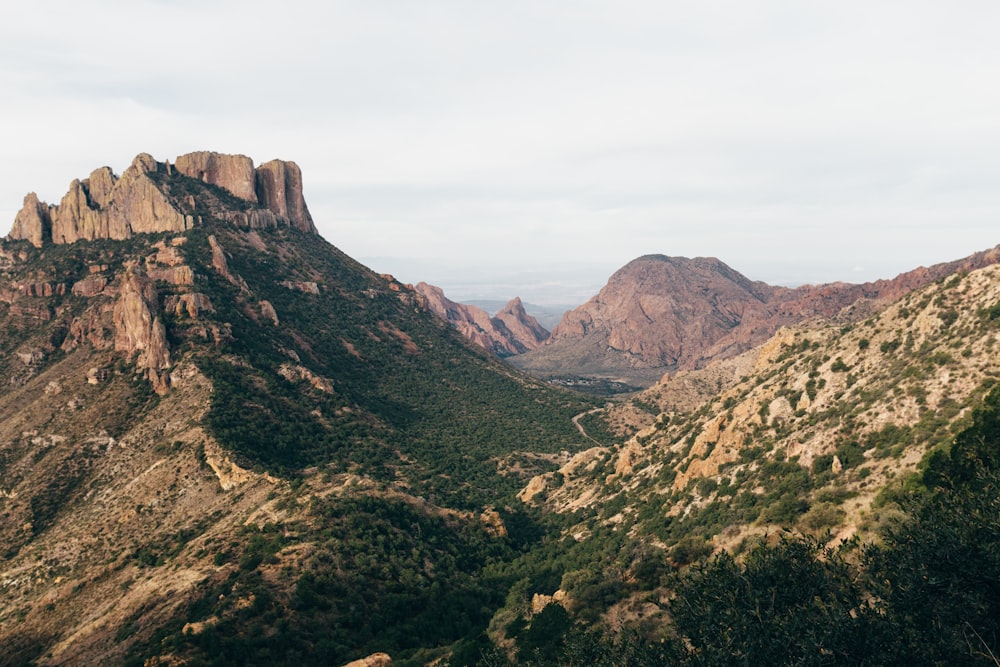 brown and green mountains under white sky during daytime