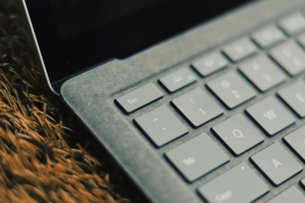 black computer keyboard on brown textile