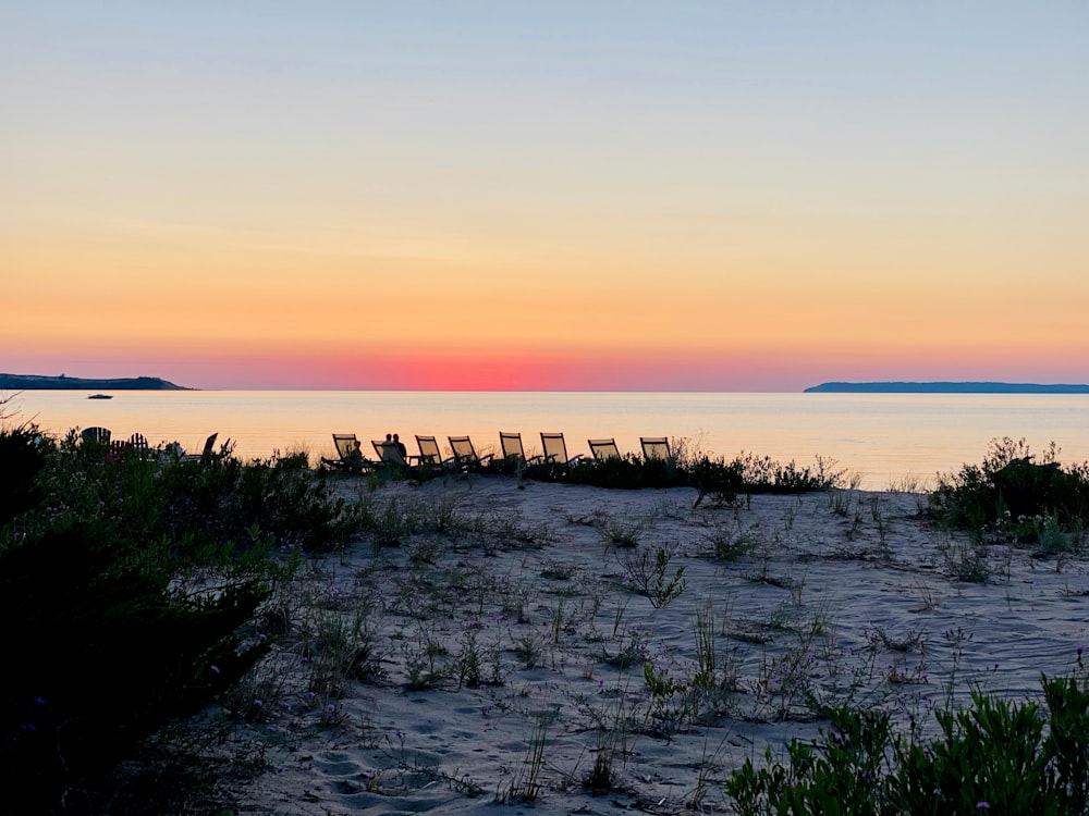 gray rocks on sea shore during sunset