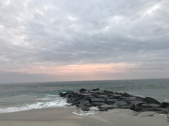 black rocks on seashore under cloudy sky during daytime in Broadway Beach United States