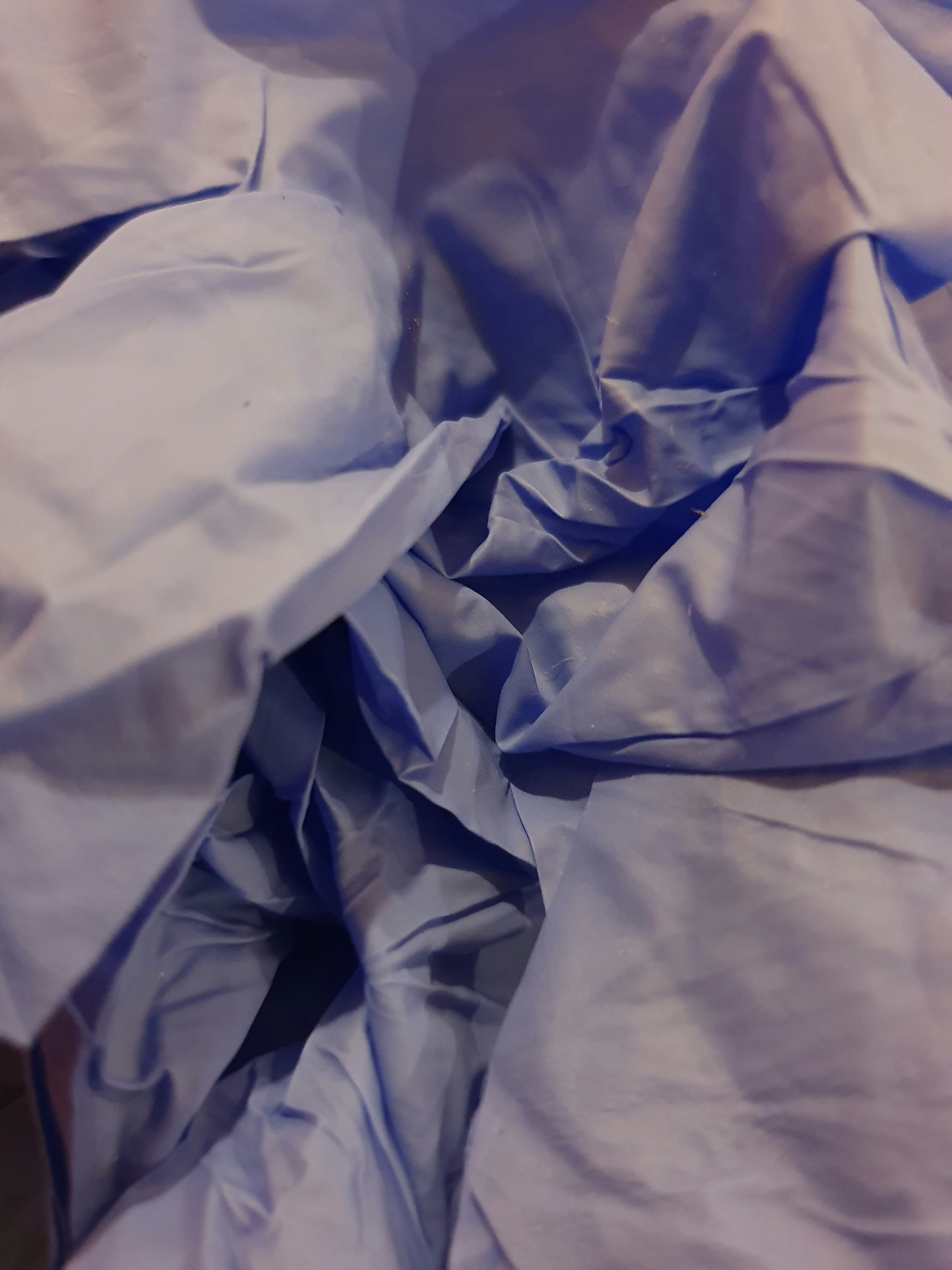 white textile on brown wooden table