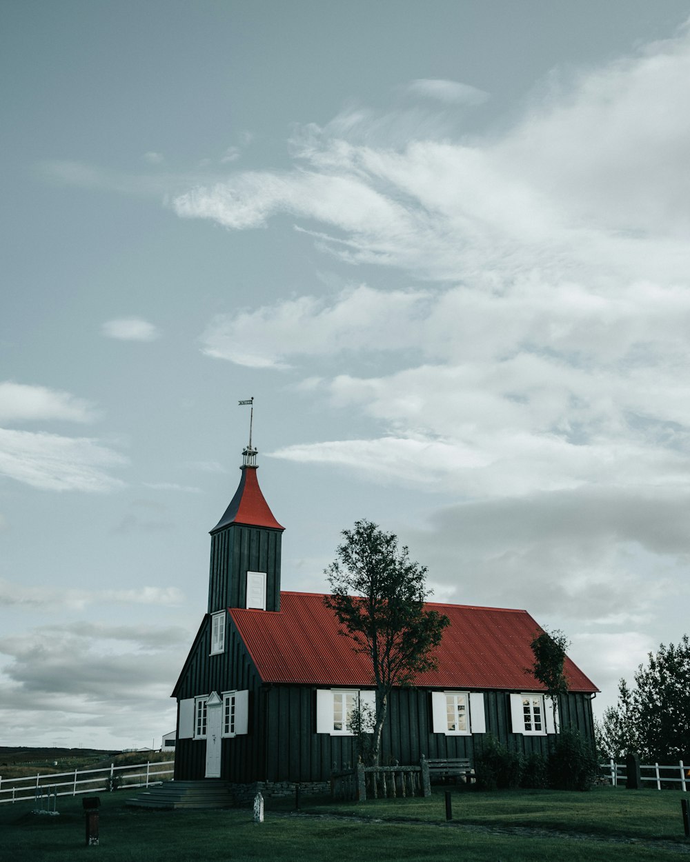 white and red wooden house under cloudy sky during daytime