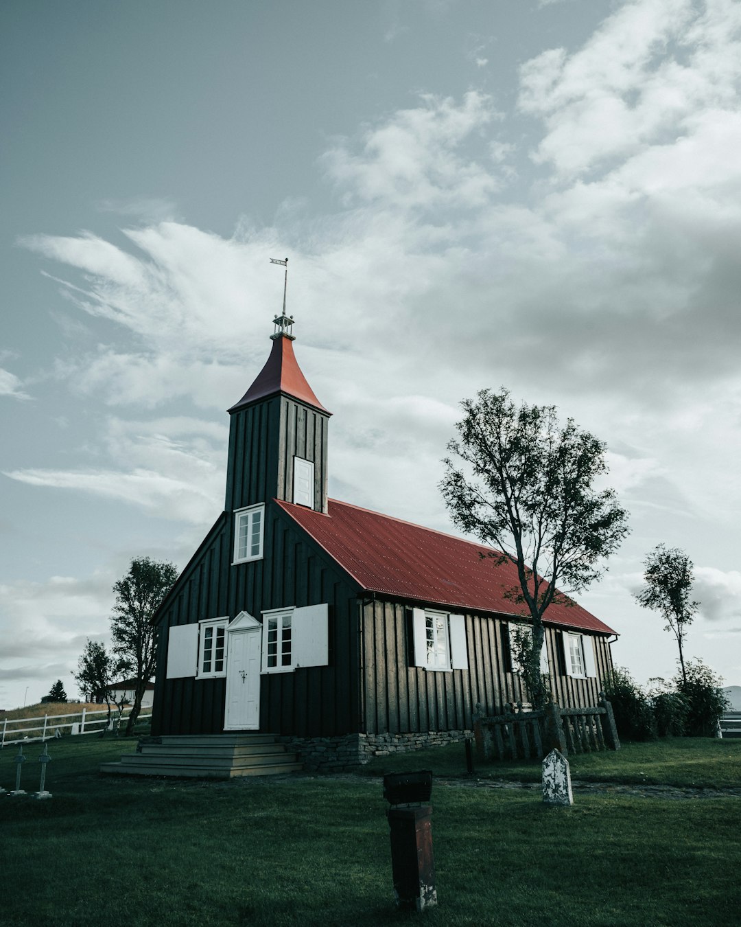 white and red concrete building under white clouds during daytime