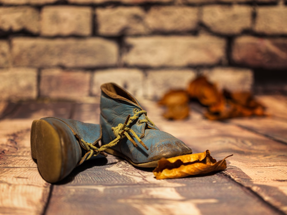 black and brown leather boots on brown wooden floor