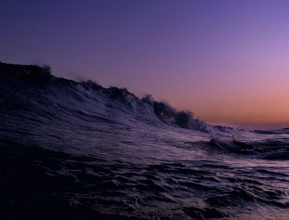 a person riding a surfboard on top of a wave