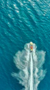 Close-up of a polished jet ski hull reflecting sunlight on calm water