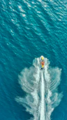 Close-up of a polished jet ski hull reflecting sunlight on calm water