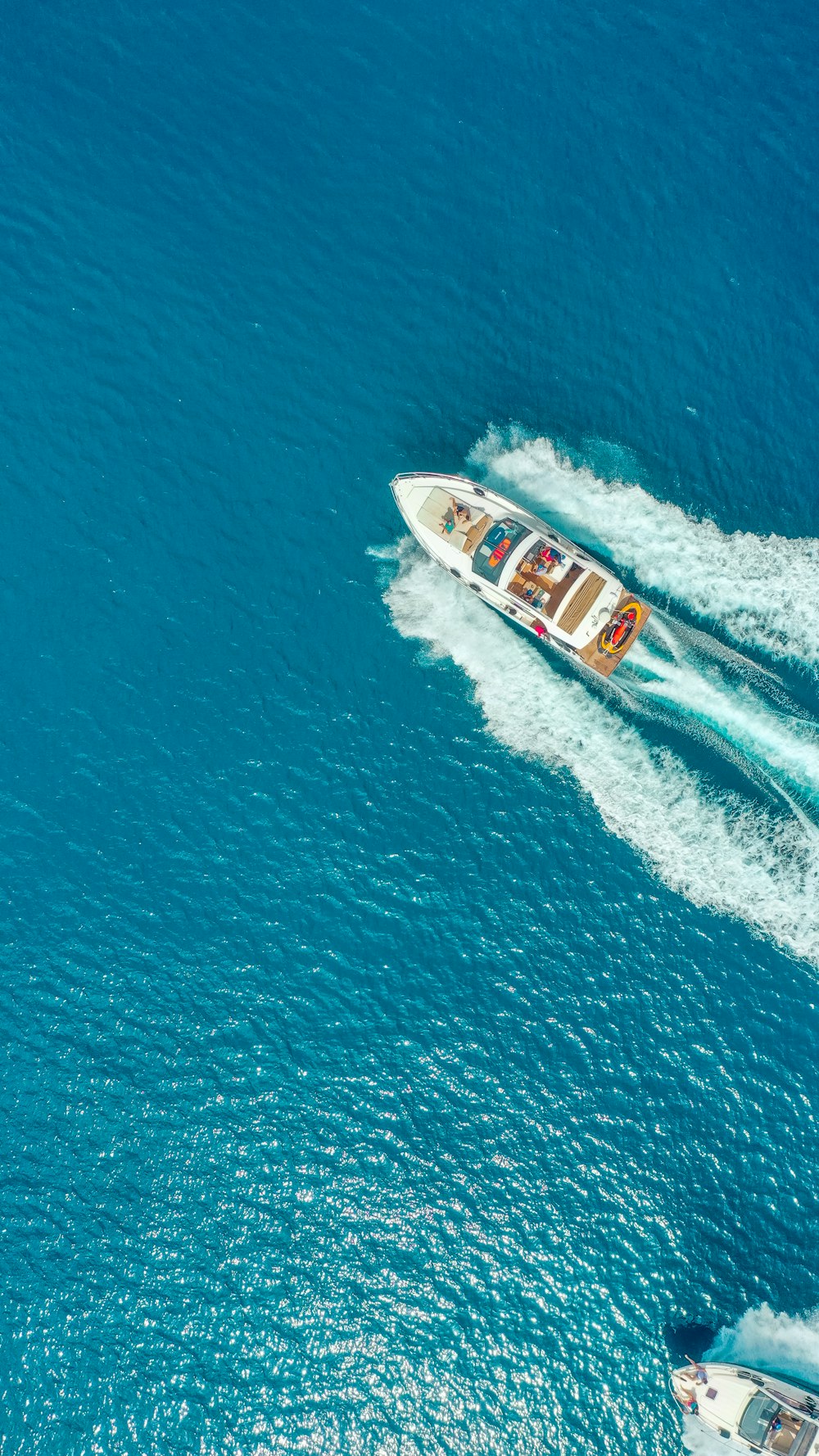 white and red boat on blue sea during daytime