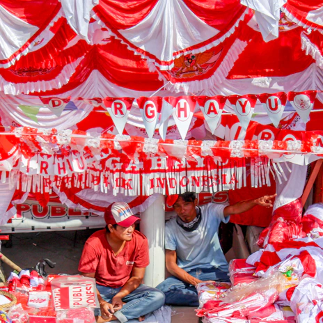 A vibrant display of red and white flags hanging outside a community center during Indonesia's Independence Day.