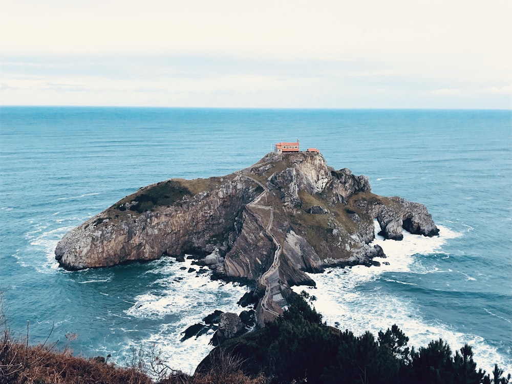 brown rock formation on sea during daytime