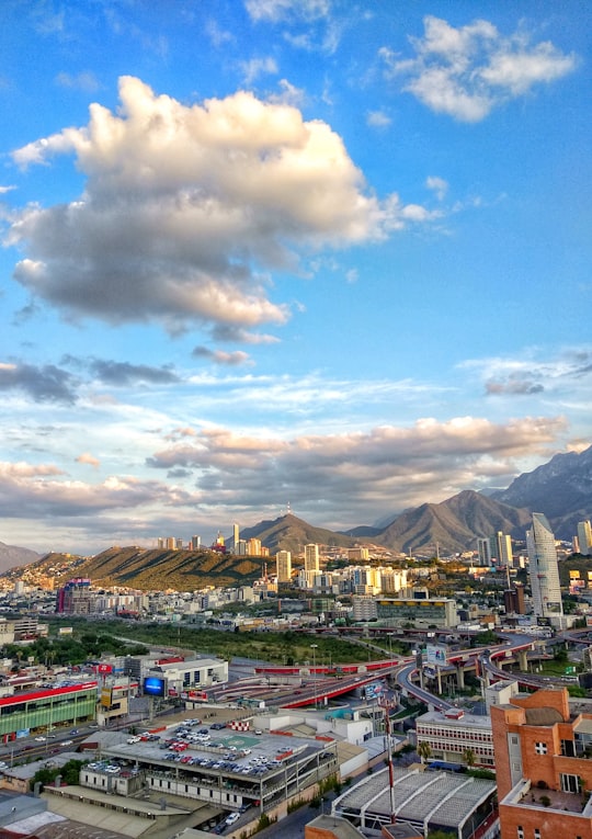 city buildings under blue sky and white clouds during daytime in Monterrey Mexico