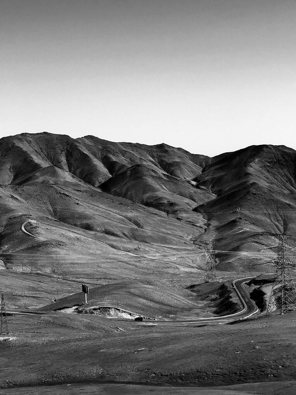 grayscale photo of mountains and trees