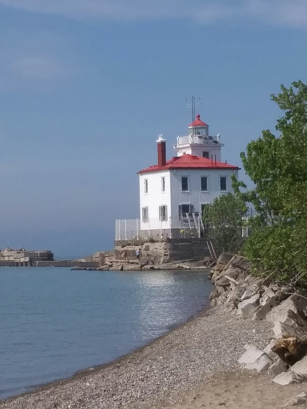 white and red concrete building near body of water during daytime