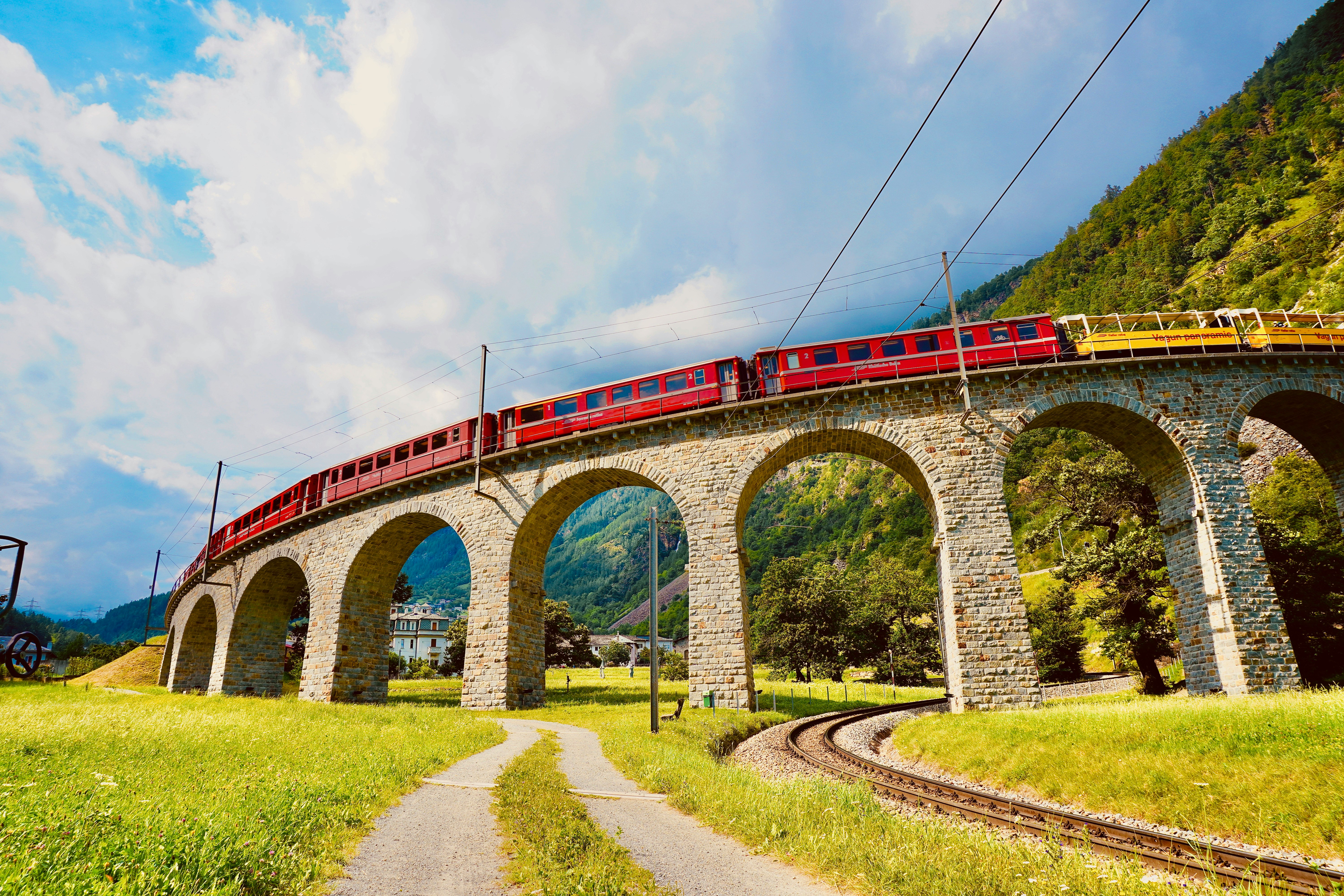 red and white bridge under cloudy sky during daytime