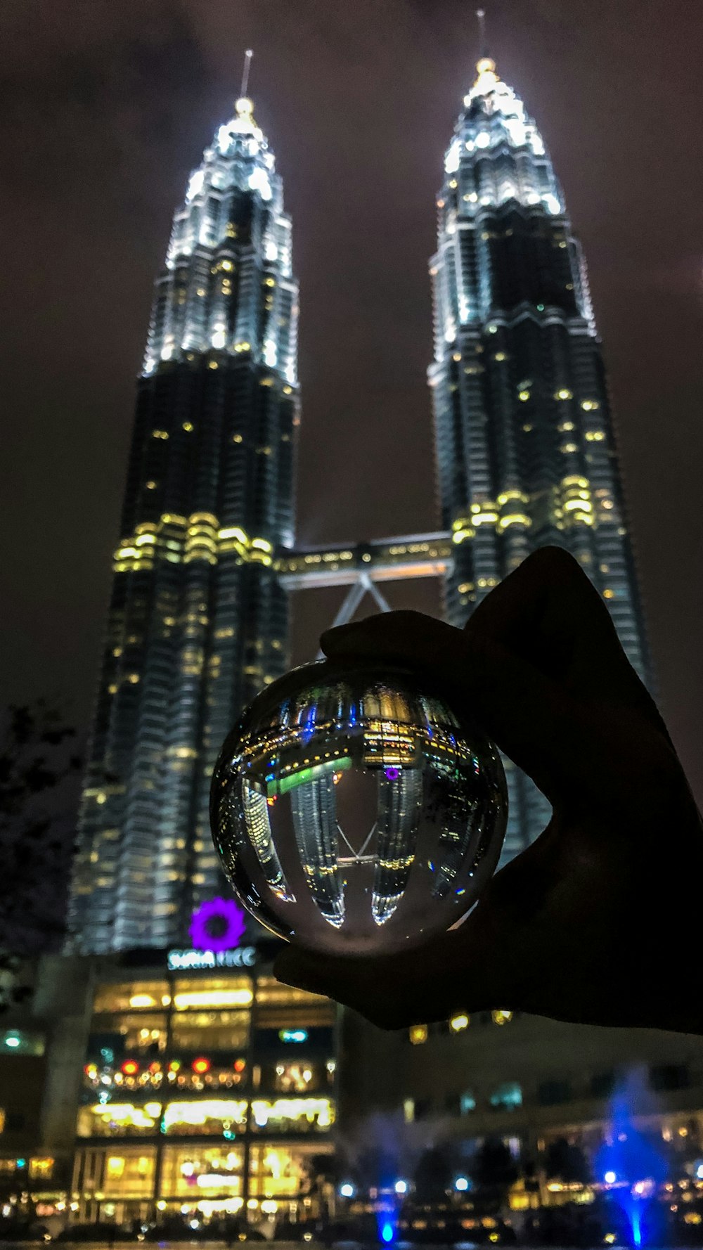 person holding clear glass ball