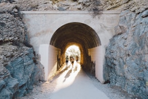 a group of people walking through a tunnel