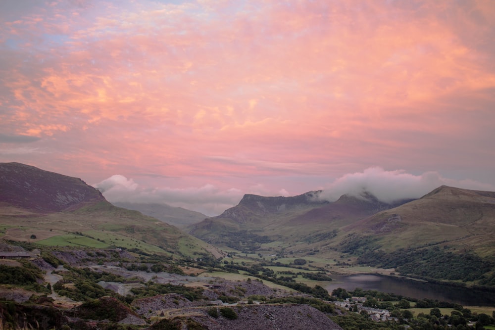 green mountains under white clouds during daytime