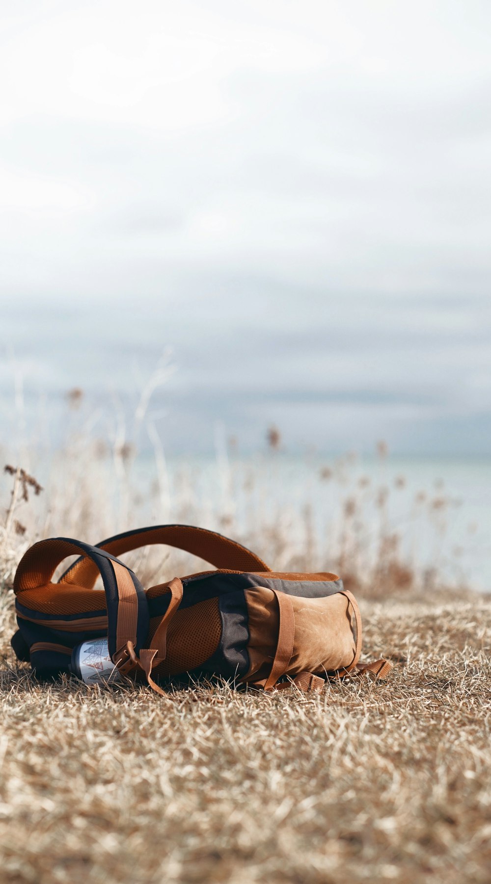 brown leather hiking sandals on brown sand during daytime