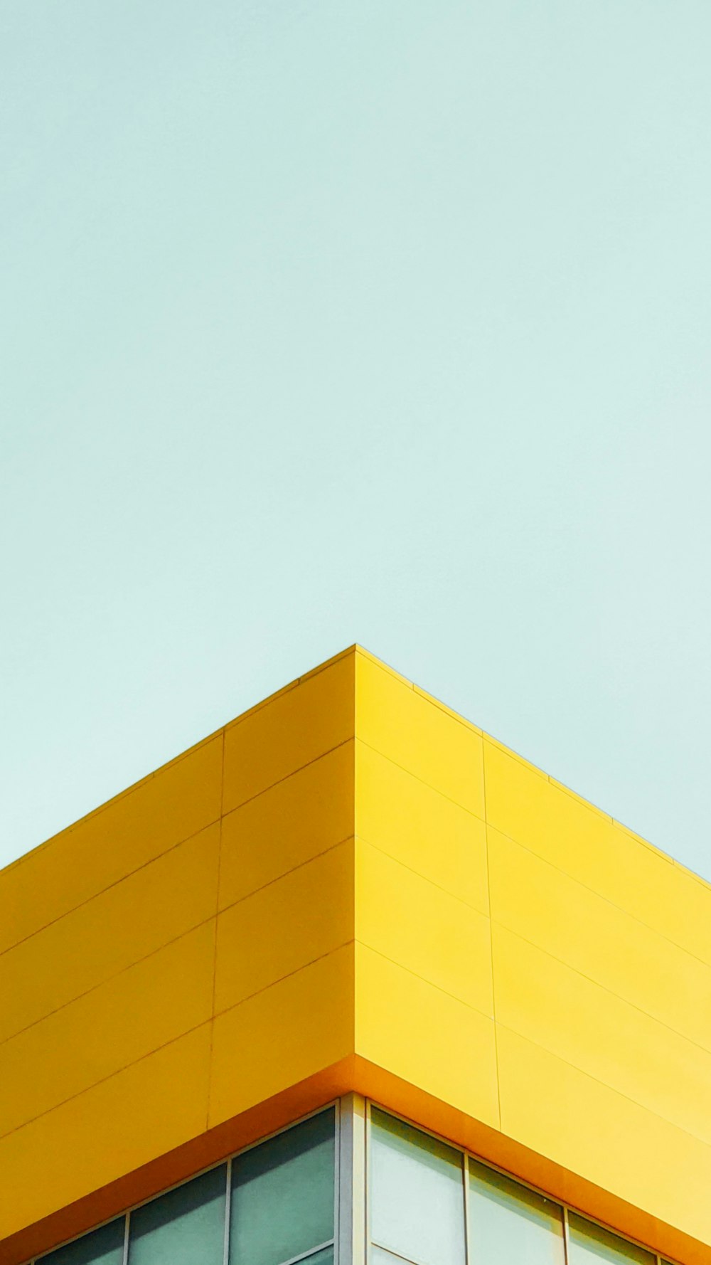 yellow concrete building under white sky during daytime
