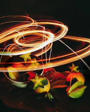 Artistic shot of freeze-dried fruit pieces floating against a dark background with neon cosmic hues.