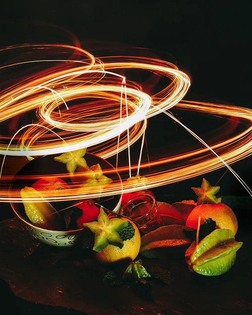 Colorful frozen fruit snacks arranged artistically with neon cosmic lighting.