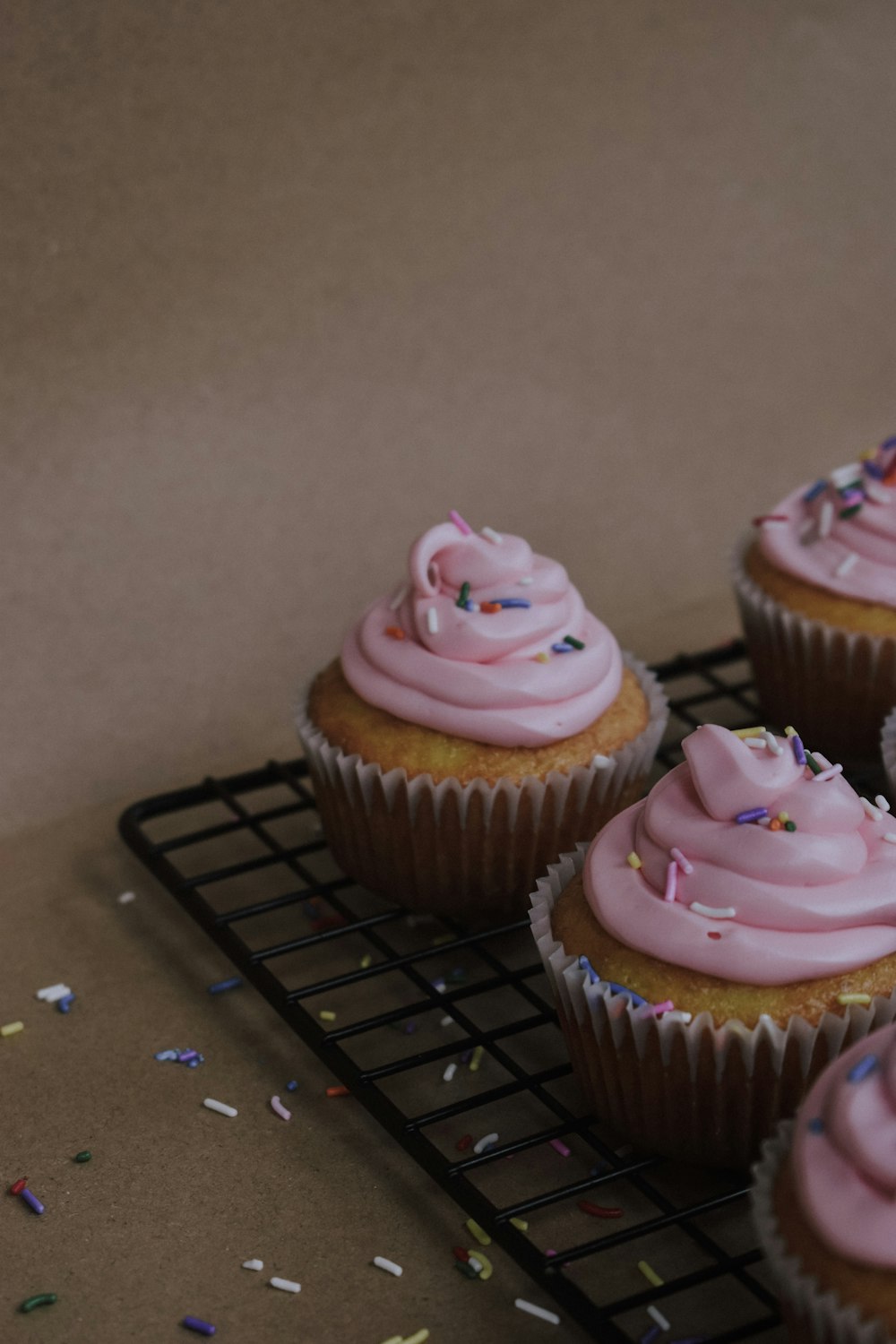 pink cupcake on black metal tray