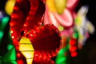A vibrant LED cascade with figure shapes glowing softly in a dark garden setting.